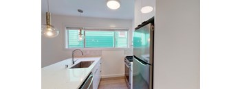 a kitchen with a sink and a refrigerator