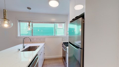 a kitchen with a sink and a refrigerator