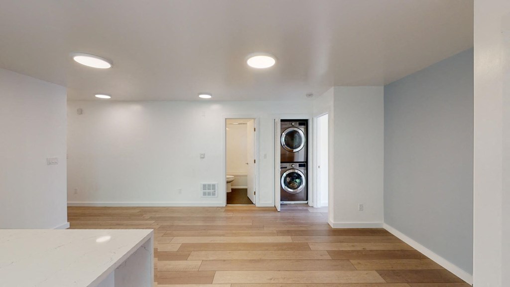 a laundry room with a washer and dryer in a white room