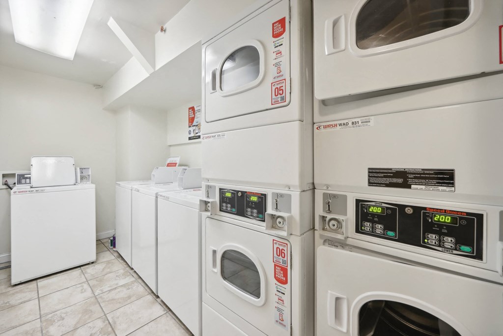 Laundry room with washing machines neatly arranged on a wooden floor
