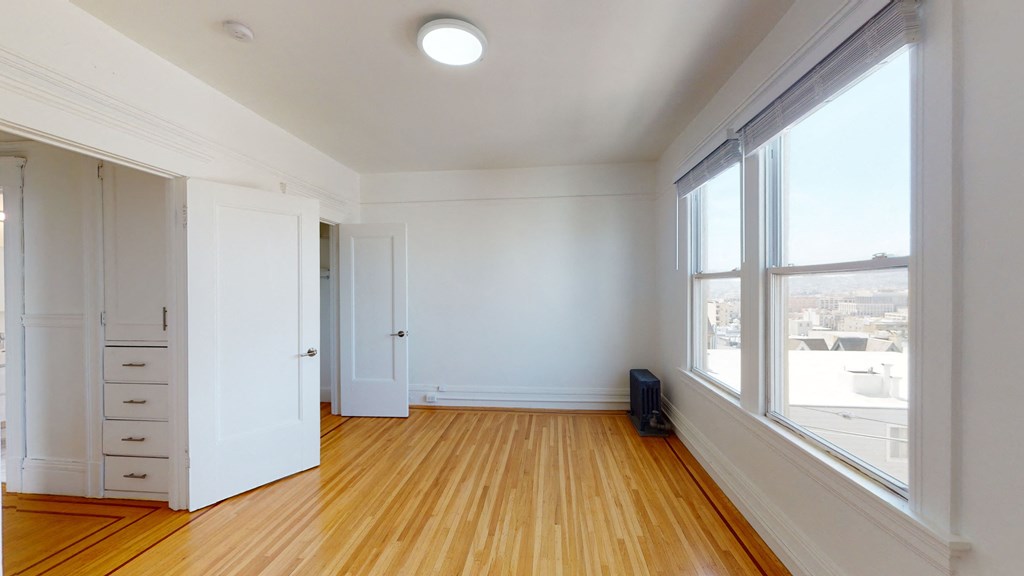 an empty living room with large window