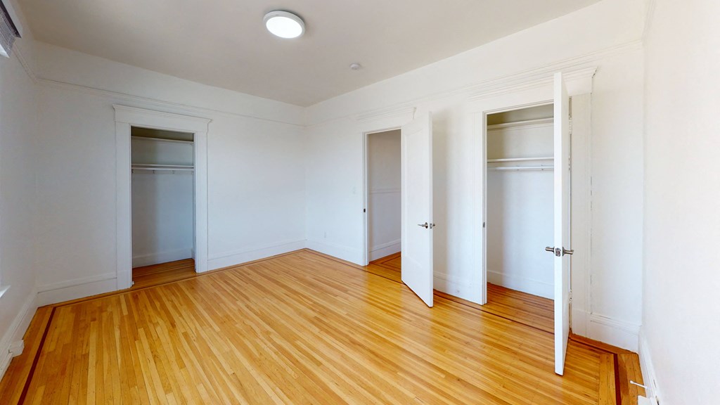 an empty living room with large window