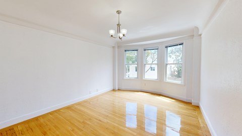 A room with wooden floors and a chandelier.