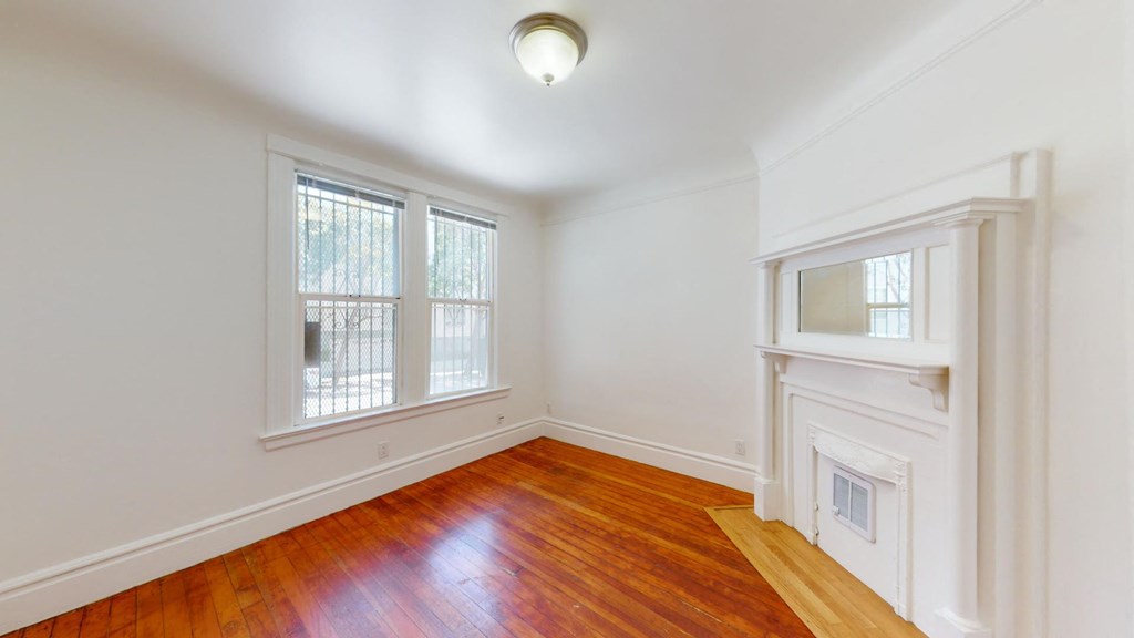 a living room with a fireplace and a window
