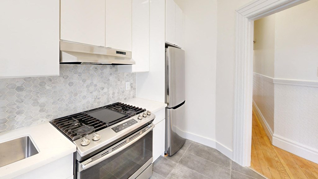 a kitchen with a stove and a refrigerator