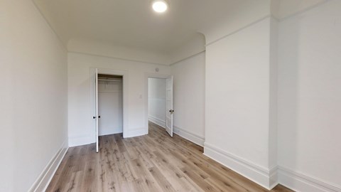 A room with a wooden floor and white walls.