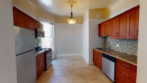 a kitchen with stainless steel appliances and wooden cabinets