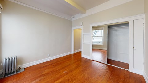 A room with wooden floors and a window.