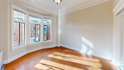 A room with wooden floors and a chandelier.