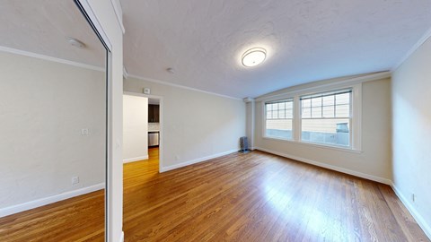 A room with wooden floors and a window.