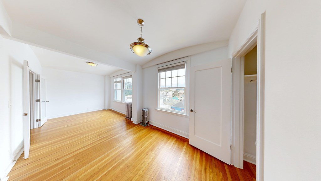 A room with wooden floors and white walls.