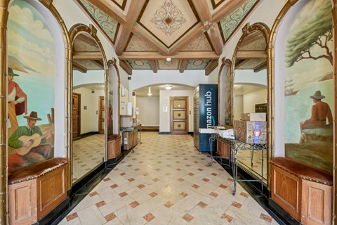 A hallway with a mural of a man playing guitar on the wall.
