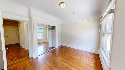 A room with wooden floors and white walls.