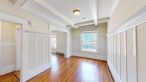 A room with wooden floors and white walls.