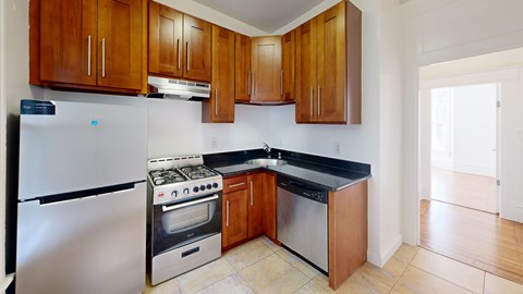 A kitchen with wooden cabinets and stainless steel appliances.