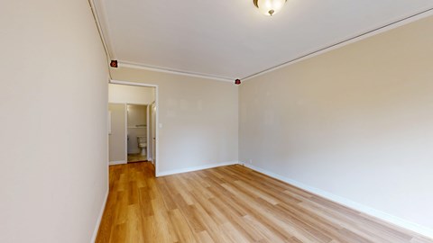 A room with wooden floors and white walls.