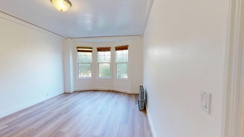 A room with a window and a door.