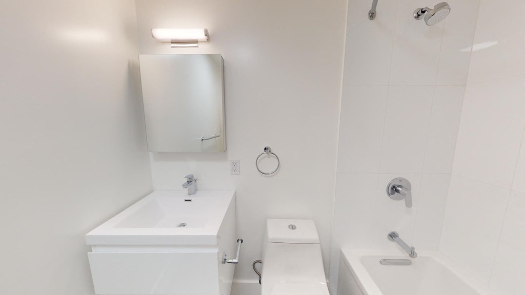 a white bathroom with a toilet and a sink