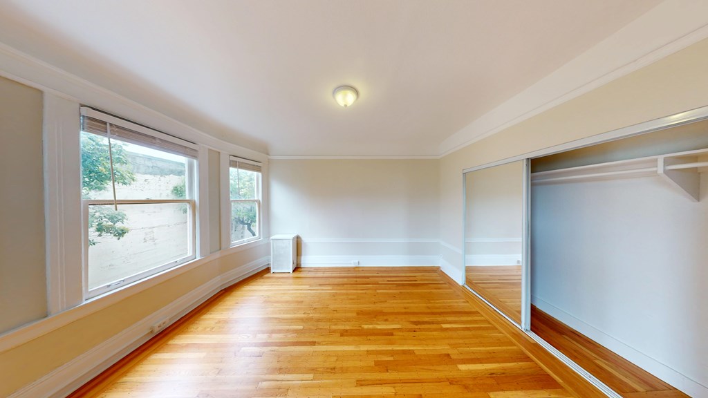 A room with wooden floors and white walls.