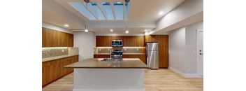 a kitchen with a counter top and a stainless steel refrigerator