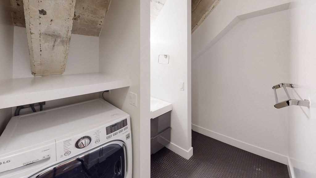 a washer and dryer in a room with a sink and a washing machine