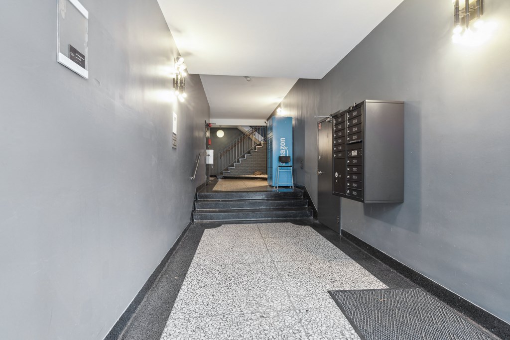 Hallway with staircase and mailboxes