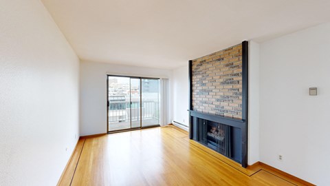 A room with a fireplace and a large window.