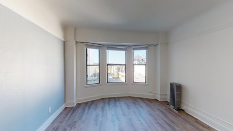 A room with a window overlooking a street.