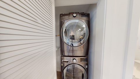 A washing machine is installed in a wall.