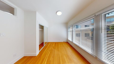 A room with wooden floors and white walls.