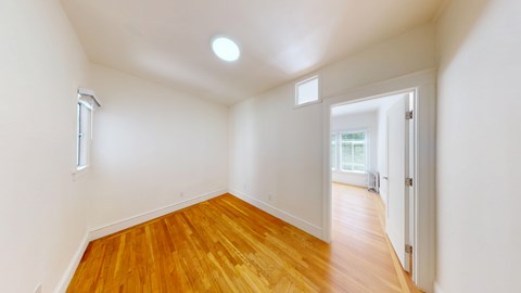 A room with wooden floors and white walls.