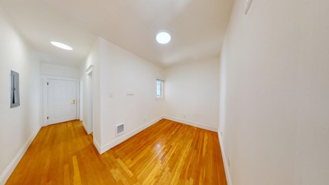 A room with wooden floors and white walls.