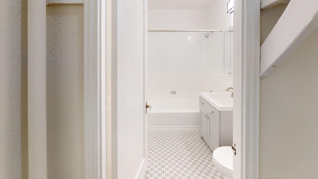 a bathroom with a sink and a toilet and a shower