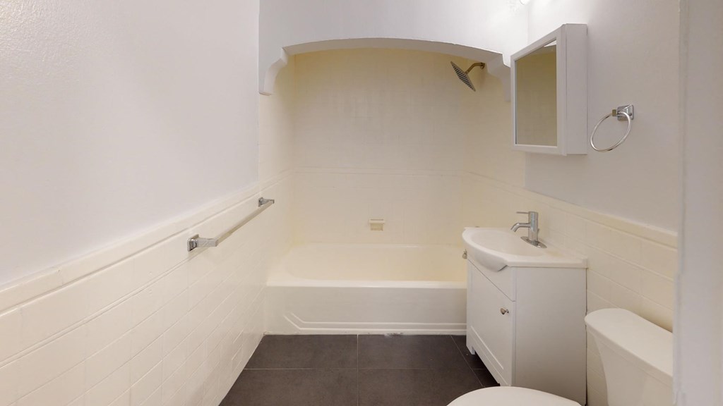 a bathroom with a sink toilet and a bath tub