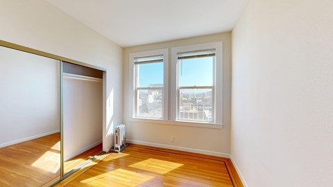 A room with a sliding glass door and a window.