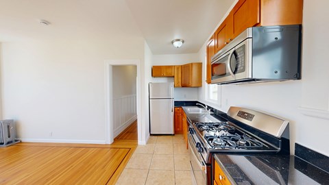 A kitchen with a stove top oven and a microwave above it.
