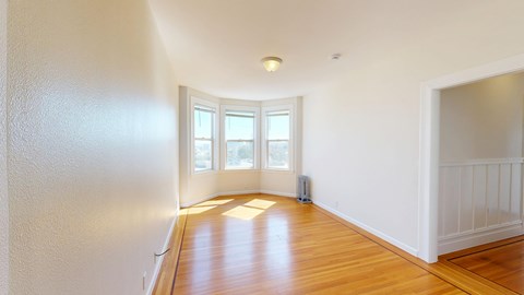 A room with wooden floors and white walls.