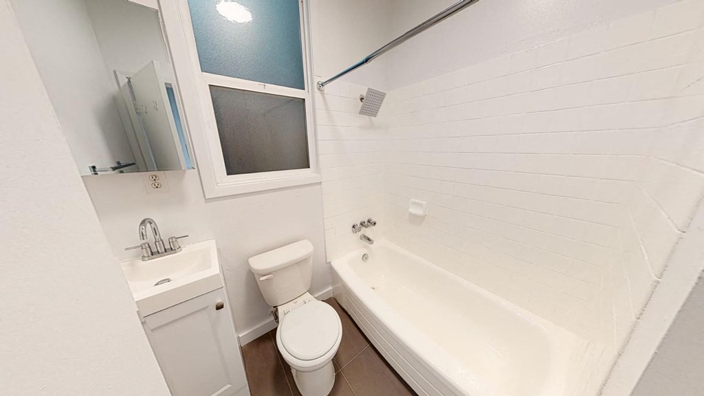 a bathroom with a tub and a toilet and a sink
