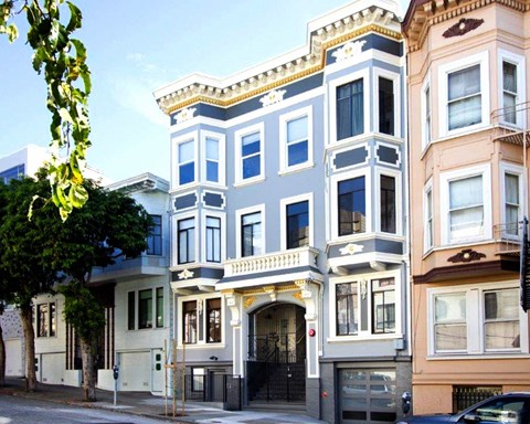 a blue and white building on a city street