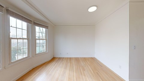 A room with wooden floors and white walls.