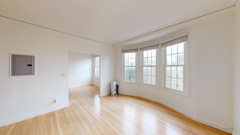 A room with wooden floors and white walls.