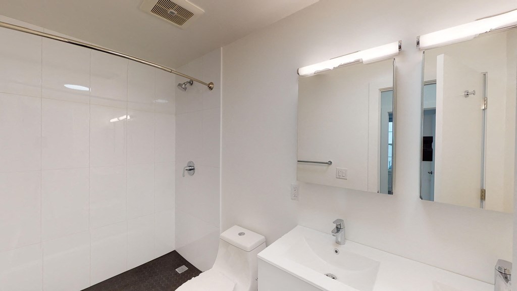 a bathroom with a sink and a toilet and a mirror