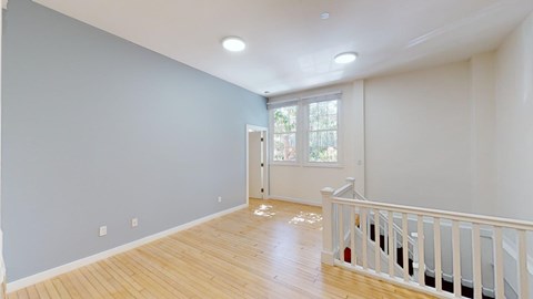 A room with wooden floors and white walls.