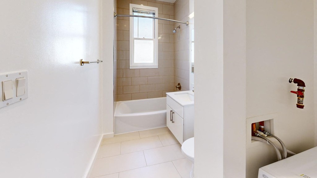 a bathroom with a tub and a sink and a toilet