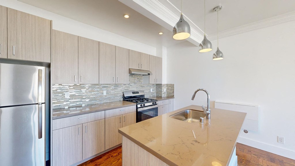 a kitchen with white cabinets and a counter top
