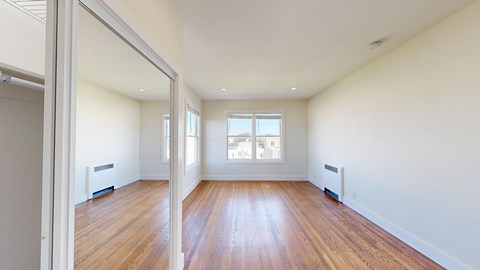 A room with wooden floors and white walls.