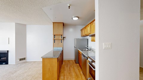 A kitchen with wooden cabinets and a refrigerator.
