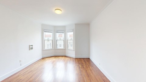 A room with wooden floors and white walls.