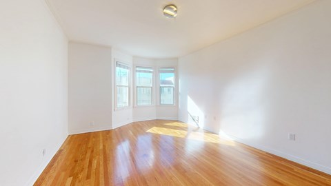 A room with wooden floors and white walls.