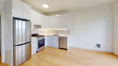 a kitchen with white cabinets and stainless steel appliances